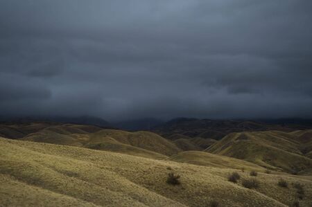 Blue storm clouds above a desert landscape.の写真素材