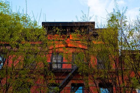 Old brick apartment building in a big city.