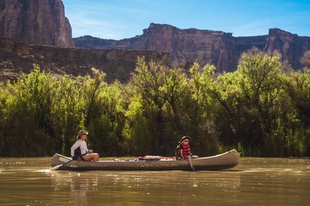 Mother and daughter paddling a canoe on Green River, Utahの写真素材