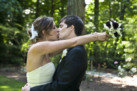 Bride and groom kissing on wedding dayの写真素材