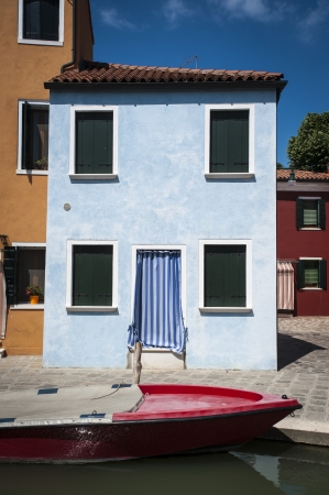 Boat docked on a canal, Burano, Italyの写真素材
