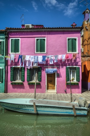 Boat docked on a canal, Burano, Italyの写真素材