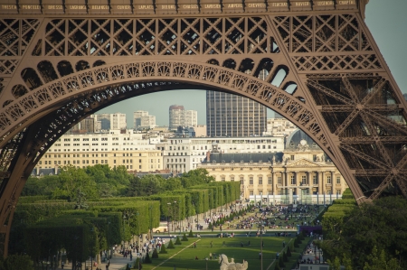Paris parks and buildings seen through legs of Eiffel Towerの写真素材