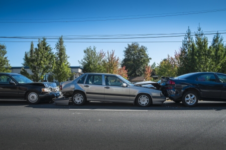 Three cars involved in an accident on a city streetの写真素材