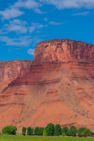 Gorgeous Utah landscape with red Butte and farm near Moab
