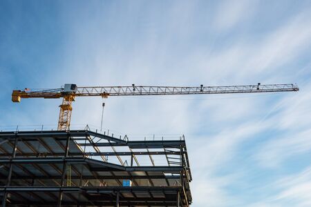 Crane used in building construction against blue sky