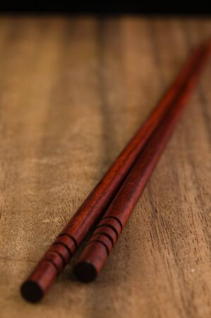 Chopsticks on a wood cutting boardの写真素材
