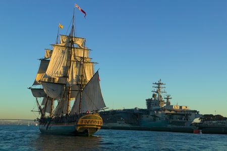 Tall Sailing Ship past a Nuclear Powered Aircraft Carrier