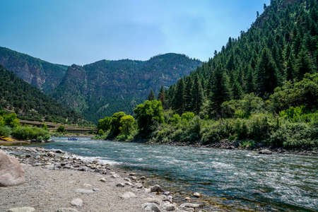 An area of the Colorado River where you can see rafters on the river along with trains passing by.の写真素材