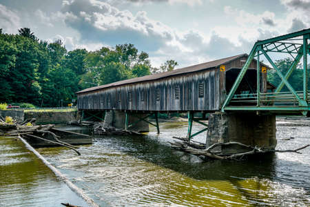 This is Harpersfield Covered Bridge that spans the Grand River in northeast Ohio the bridge is over a hundred years old and cars still cross it every day.の写真素材