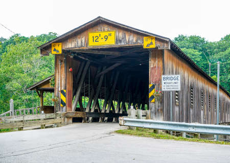This is Harpersfield Covered Bridge that spans the Grand River in northeast Ohio the bridge is over a hundred years old and cars still cross it every day.の写真素材