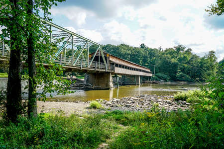 This is Harpersfield Covered Bridge that spans the Grand River in northeast Ohio the bridge is over a hundred years old and cars still cross it every day.の写真素材