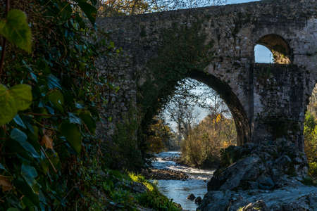 Cangas de Onis Spain where a Roman bridge built in the late 13th century spans the Sella River.の写真素材