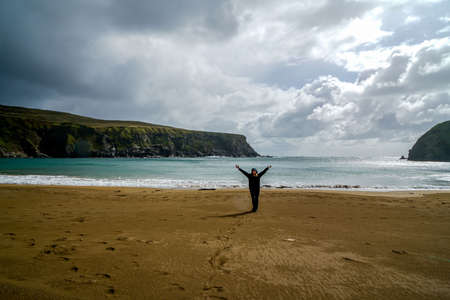 A beautiful crescent shaped beach in Glencolmkille Ireland.の写真素材