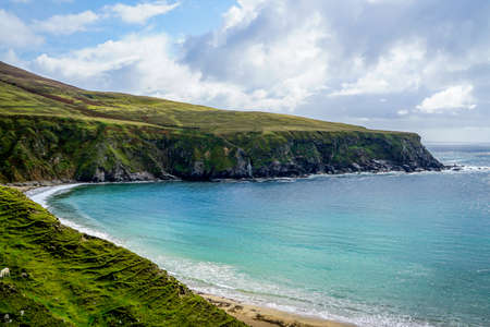 A beautiful crescent shaped beach in Glencolmkille Ireland.の写真素材