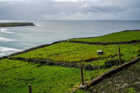 The landscape of Glencolmkille Ireland rolling hills and beautiful meadows.の写真素材