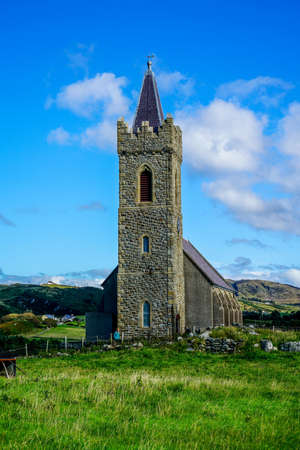 The standing stone is called a Turas it was created between the eighth and ninth century it stands about one hundred yards away from the Church of Ireland in Glencolmkille county Donegal.の写真素材