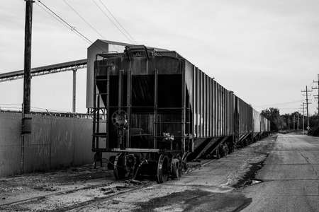 A small train and train cars sitting outside of the salt mines on Lake Erie in Northeast Ohio.の写真素材