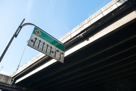 A green road sign with arrows.の写真素材