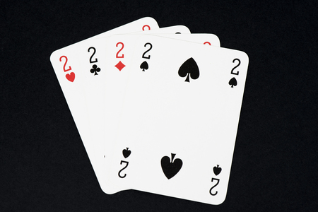 Playing card on black table, four of a kind cards