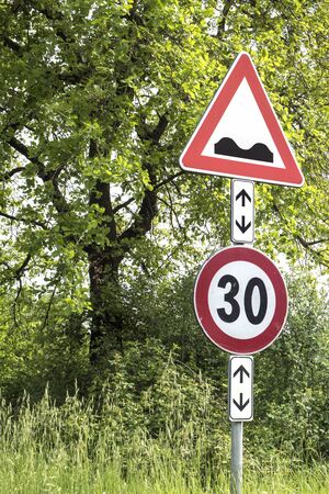 Road Sign Caution Speed Bumps Ahead in the meadow