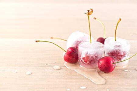 Frozen cherries on wooden tableの写真素材