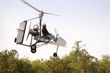 Gyrocopter in flight (face intentionally obscurred)の写真素材