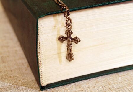 Bible and a metal cross with Jesus on a chainの写真素材