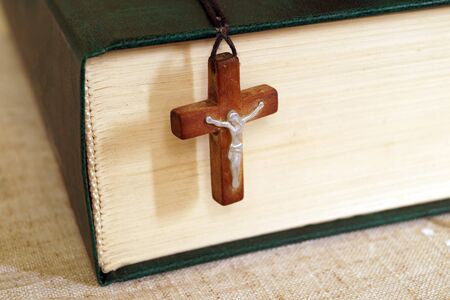Holy Bible and a wooden cross with Jesusの写真素材