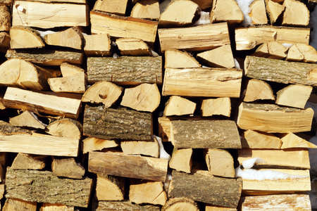 Chopped wood, stacked in a woodpile. Solid ecological fuel for heating the house in winter frost....