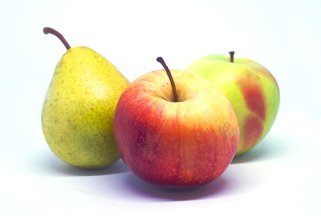 Two apples and pear on white background. Selective focus.の写真素材