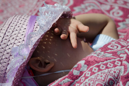 Young girl taking a nap in the sunの写真素材