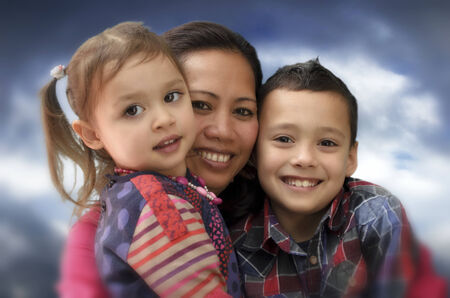 Mother hugging her childrenの写真素材