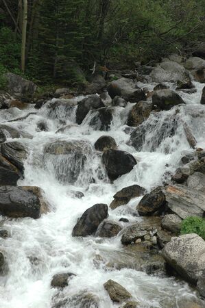 A fast moving stream runs down from the cold mountains.