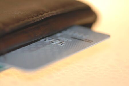 A  platinum credit card edge in a brown leather wallet.の写真素材