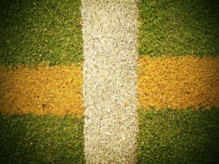 Colorful lines in outdoor handball playground, plastic light green surface on the ground and white,...