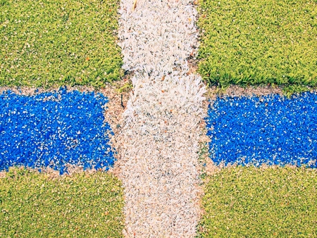Colorful lines in outdoor handball playground, plastic light green surface on the ground and white, red and blue lines bounds.の写真素材