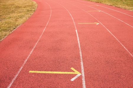 White lines and texture of running racetrack, red rubber racetracks in outdoor stadiumの写真素材