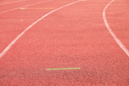White lines and texture of running racetrack, red rubber racetracks in outdoor stadiumの写真素材