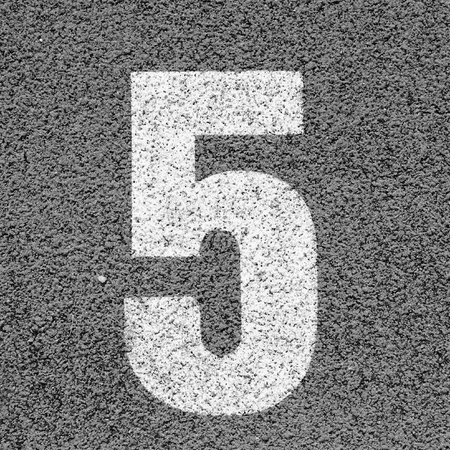 White track number on red rubber racetrack, texture of running racetracks in small stadiumの写真素材