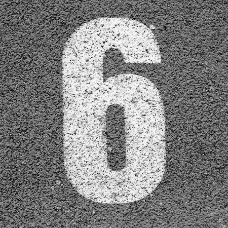 White track number on red rubber racetrack, texture of running racetracks in small stadiumの写真素材
