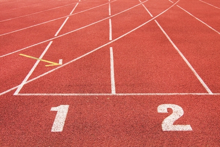 White track number on red rubber racetrack, texture of running racetracks in small stadium