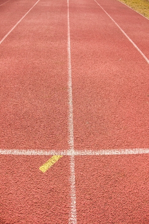 White lines and texture of running racetrack, red rubber racetracks in outdoor stadiumの写真素材