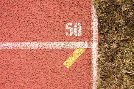 White lines and texture of running racetrack, red rubber racetracks in outdoor stadiumの写真素材
