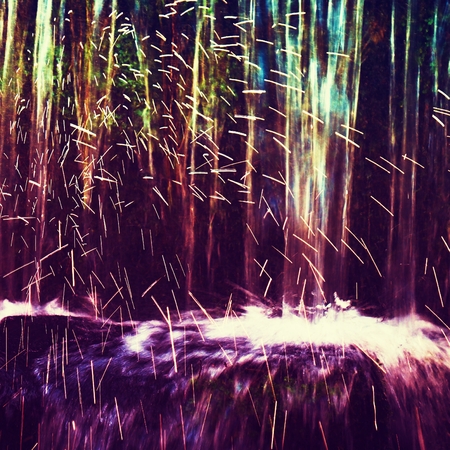 Shinning drops. Cascade of small weir on mountain stream, big mossy boulders.の写真素材