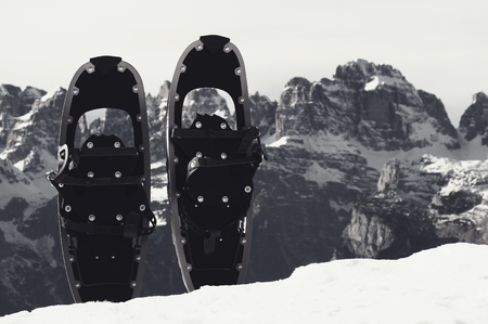 Snowshoes in snow at mountain peak, nice sunny winter dayの写真素材