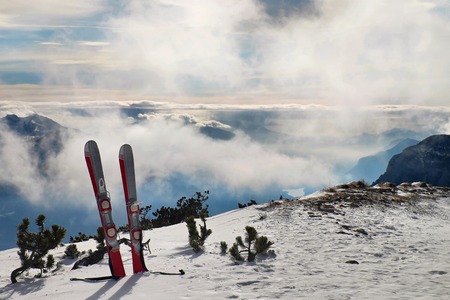 Small fun skis in snow at mountains, nice sunny winter day at peakの写真素材