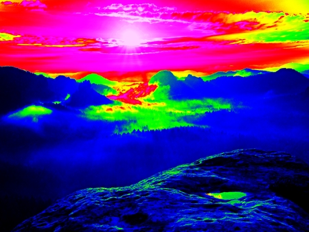 Amazing thermography photo of hilly landscape. Autumn sunset above long deep valley with forest.