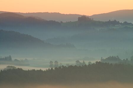 Misty autumn mountain hills landscape. Filtered image with cross processed vivid effect.の写真素材