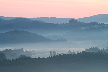Autumn fog and clouds above freeze  mountain valley, hilly landscapeの写真素材